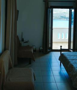 a room with a room with a view of the ocean at Panorama Appartment in Agia Marina