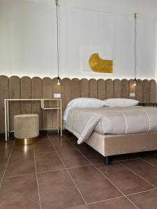 a bedroom with a large bed and a tiled floor at Villa Liliana in Cervia