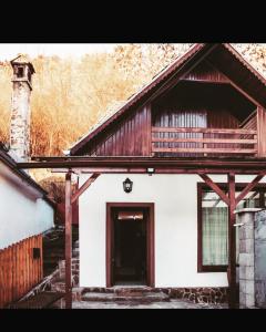 a white house with a brown and white roof at Sedra House in Sighişoara