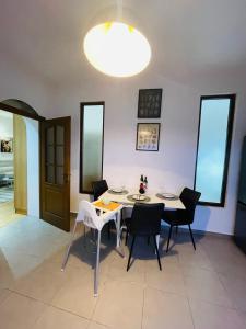 a dining room with a white table and chairs at Sedra House in Sighişoara +11 photos