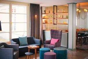 een woonkamer met kleurrijke stoelen en een tafel bij Vienna House Easy by Wyndham Castrop-Rauxel in Castrop-Rauxel
