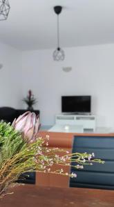 a living room with a table with flowers on it at Ellas Modern Duplex City Center in Nicosia