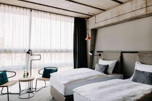 Cama ou camas em um quarto em Vienna House by Wyndham Mokotow Warsaw