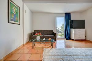 a living room with a couch and a table at The View Aix-en-Provence in Aix-en-Provence