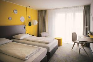 Postel nebo postele na pokoji v ubytování Vienna House Easy by Wyndham Trier