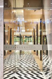 a glass door in a building with a checkered floor at Vakko Hotel and Residence in Istanbul