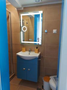 a bathroom with a sink and a mirror at Mpitzarakis Studio On the Beach in Agia Pelagia +40 photos