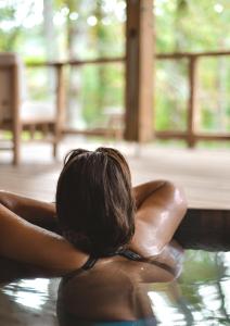 a woman in the water in a swimming pool at Hôtel Les Frères Ibarboure in Bidart