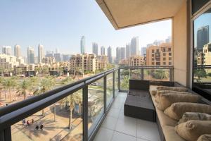 a balcony with a couch and a view of the city at New Arabian Burj Residence Downtown Dubai in Dubai