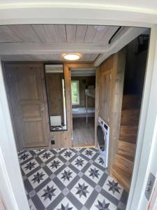 an inside view of an rv with a black and white floor at Unik overnatting i Stabbur/Minihus in Lunde