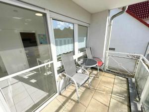 a balcony with a table and chairs on a building at Nice 2,5-Room Apartment in Untergruppenbach