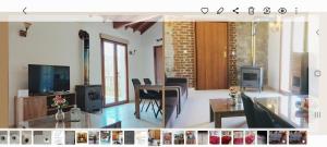 a living room with a table and a dining room at Love Holiday Suite 1 in Tris Elies
