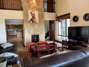 a living room with a couch and a fireplace at 211 Zebula in Mabula