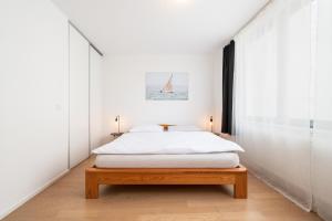 a bedroom with a bed and a sailboat on the wall at Mill Apartments in Brno