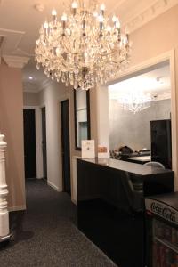 a chandelier is hanging over a counter in a room at Sara's Boutique Hotel in Amsterdam