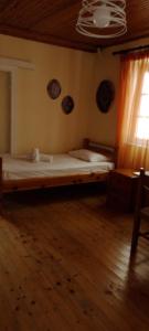 a large bed in a room with a window at Dora's happy apartment in Mantoúkion