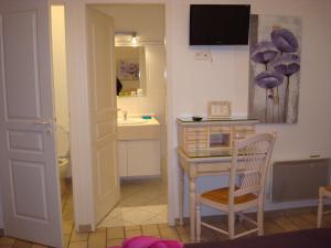 a bathroom with a table and a sink and a toilet at Chambres "Blanches" , bâtiment secondaire hotel la Caravelle, vue jardin in Biscarrosse-Plage