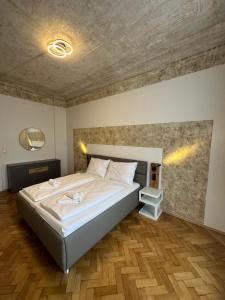 a bedroom with a bed and a wooden floor at ARTLIVING Apartment-Top 3 Self check-in in Graz