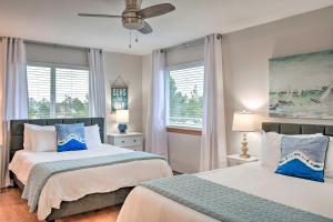 a bedroom with two beds and a ceiling fan at Canal-Front Vacation Rental in Ocean Shores in Ocean Shores