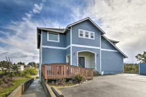 a blue house with a deck on a driveway at Canal-Front Vacation Rental in Ocean Shores in Ocean Shores