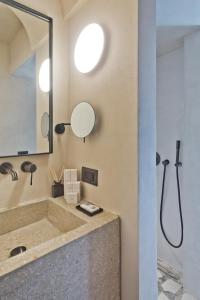 a bathroom with a sink and a mirror at Almi Luxury Rooms in Amoopi