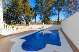 a swimming pool in the backyard of a house at CH Villa Golf Park La Marquesa in Rojales