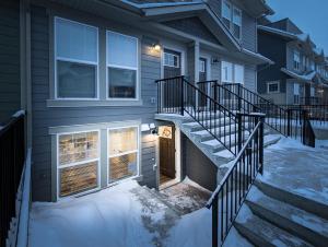 a house with a staircase leading to a door at GLOBALSTAY New Apartments in Cranbrook Free street parking in Calgary