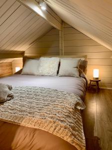 a bedroom with a large bed in a attic at Luxury Garden Lodge With Free Parking in Chestfield