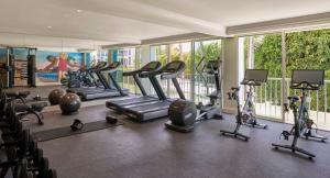a gym with treadmills and exercise equipment in a building at Viceroy Santa Monica in Los Angeles