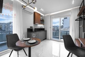 a kitchen and dining room with a table and chairs at Hermes Suites, Agia Sofia, Nilie Hospitality MGMT in Thessaloniki