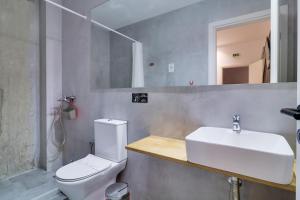 a bathroom with a white sink and a toilet at athensdot in Athens