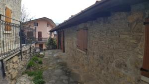 an alley in a stone building with a balcony at CASA VAL DEL RISO in Gorno