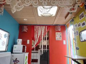 a kitchen with red walls and a ceiling at la woodstock in Xertigny