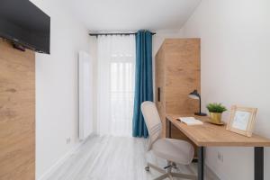 a home office with a desk and a chair at Studio Cracow Rakowicka 14 by Renters in Krakow