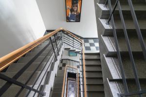 a staircase in a building with a picture on the wall at Studio Cracow Rakowicka 14 by Renters in Krakow