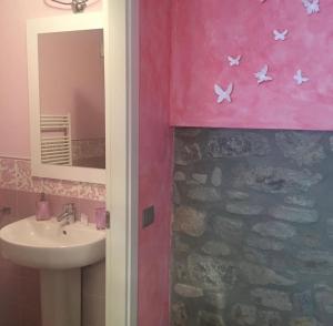 a bathroom with a sink and a mirror at B&B BuongiornoNotte in Bobbio