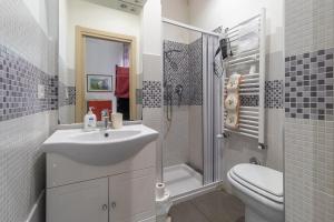 a bathroom with a sink and a shower and a toilet at Bologna Bed Station in Bologna