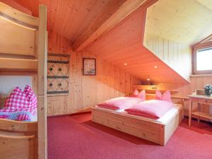 a bedroom with two bunk beds in a cabin at Berggasthof Zieplhof in Westendorf