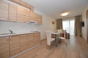 a kitchen and dining room with a table and chairs at Bears Apartments in Palanga