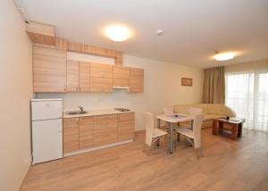 a kitchen and dining room with a table and chairs at Bears Apartments in Palanga +6 photos