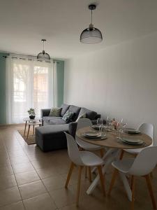 a living room with a table and a couch at Appart COSY F2 Disneyland/Val d'Europe in Montévrain