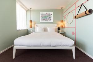 a bedroom with a white bed and a window at Conscious Hotel Vondelpark in Amsterdam