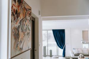 a room with a painting on the wall next to a window at Villas Elini in Perdika