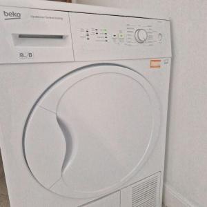 a white washing machine with its door open at Belfast City house in Belfast