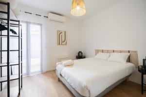 a white bedroom with a large bed and a window at MaisonMars - La Maison Du Parc 4 Standing Parking Wifi Clim in Marseille