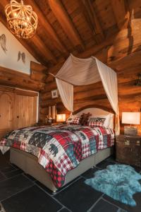 a bedroom with a bed in a log cabin at Caledonian Cabin in Invergarry