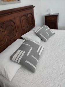 two black and white pillows on a bed at Bed&Breakfast Angela in Clusone