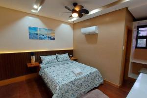 a bedroom with a bed and a ceiling fan at Cailey's Corner Family Resort in Tagaytay