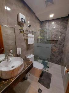 a bathroom with a sink and a shower and a toilet at Cailey's Corner Family Resort in Tagaytay