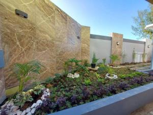 a garden in front of a building with flowers at Cailey's Corner Family Resort in Tagaytay